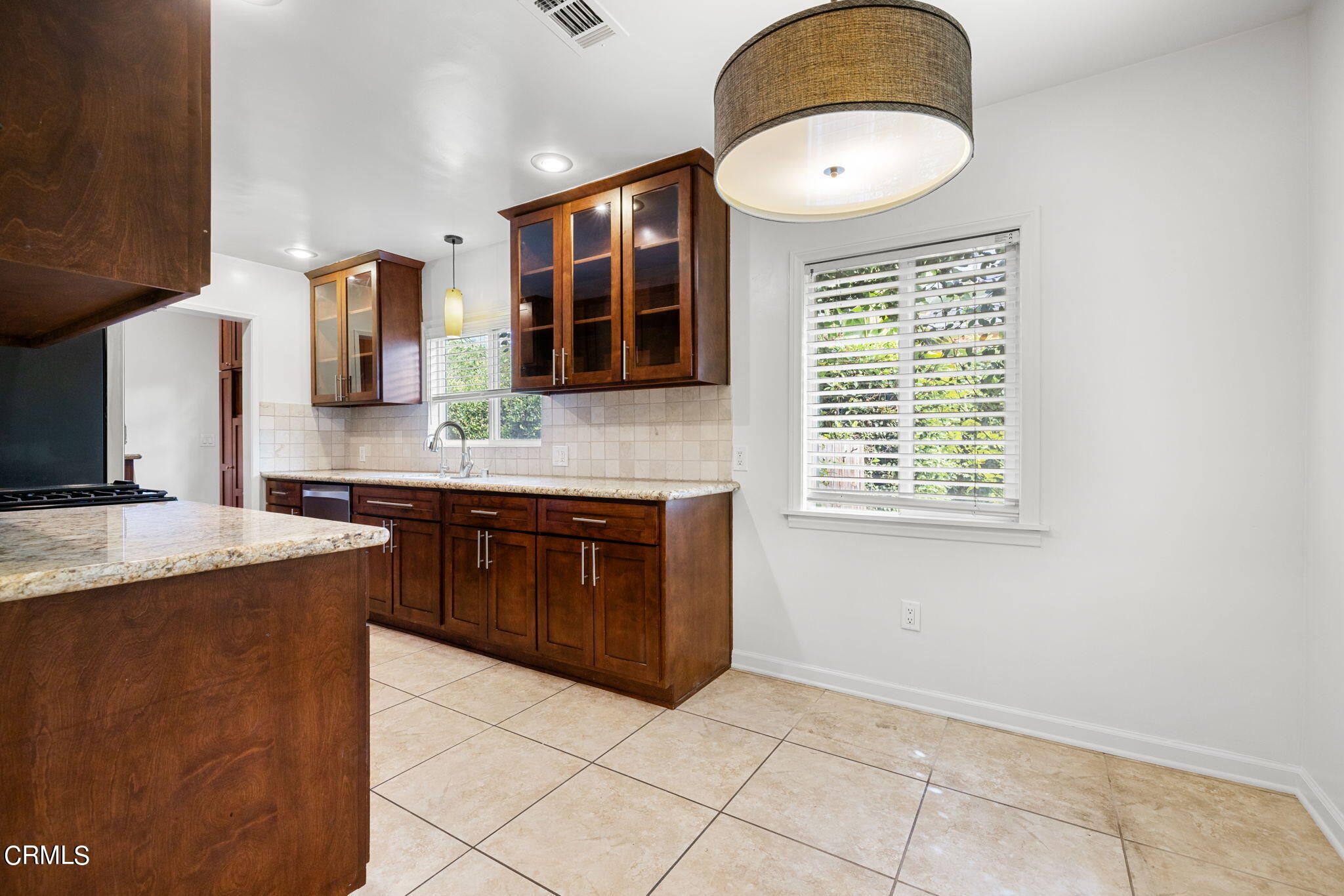 3127 Thurin Avenue Altadena, CA 91001 - Photo 8 of 23 a kitchen with stainless steel appliances granite countertop a stove a sink and a microwave