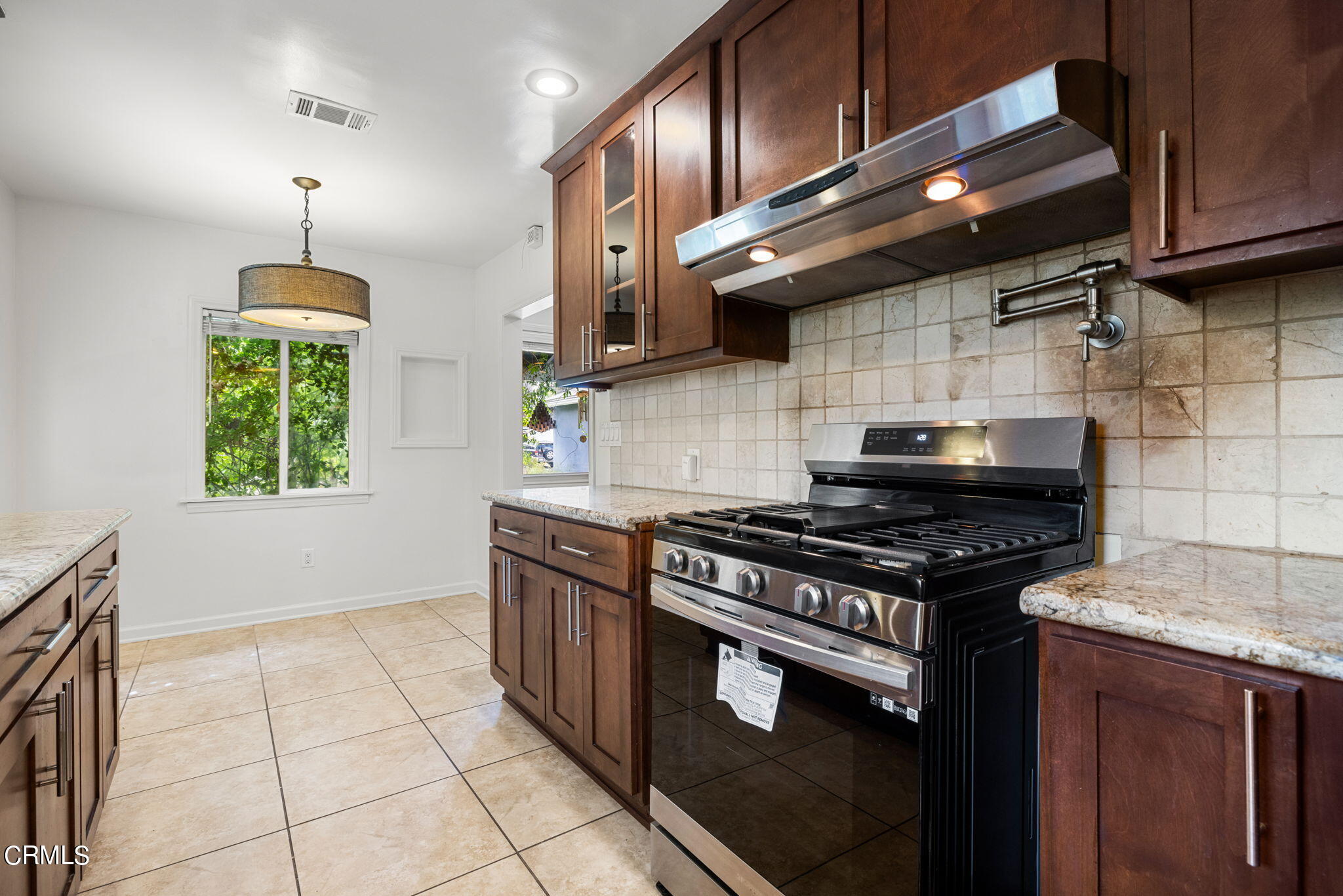 3127 Thurin Avenue Altadena, CA 91001 - Photo 10 of 23 a kitchen with granite countertop a stove top oven a sink a counter space and cabinets