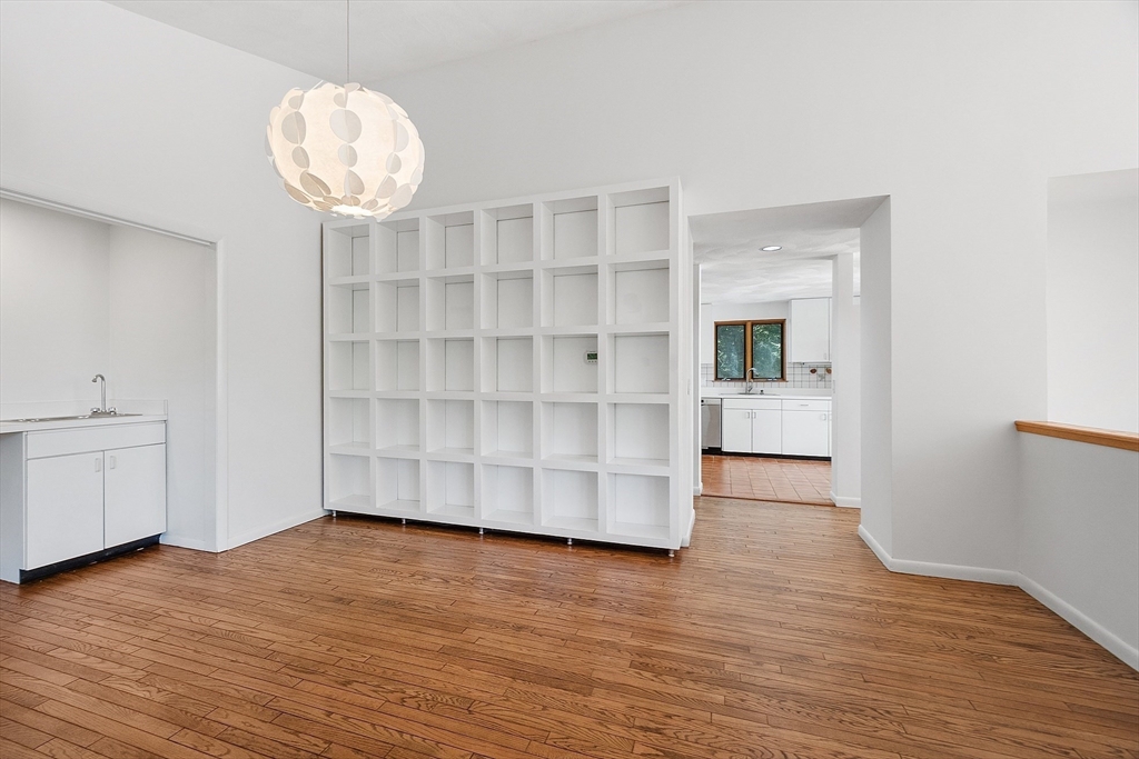 56 Old Littleton Road Harvard, MA 01451 - Photo 11 of 26 a view of an empty room with wooden floor and a window