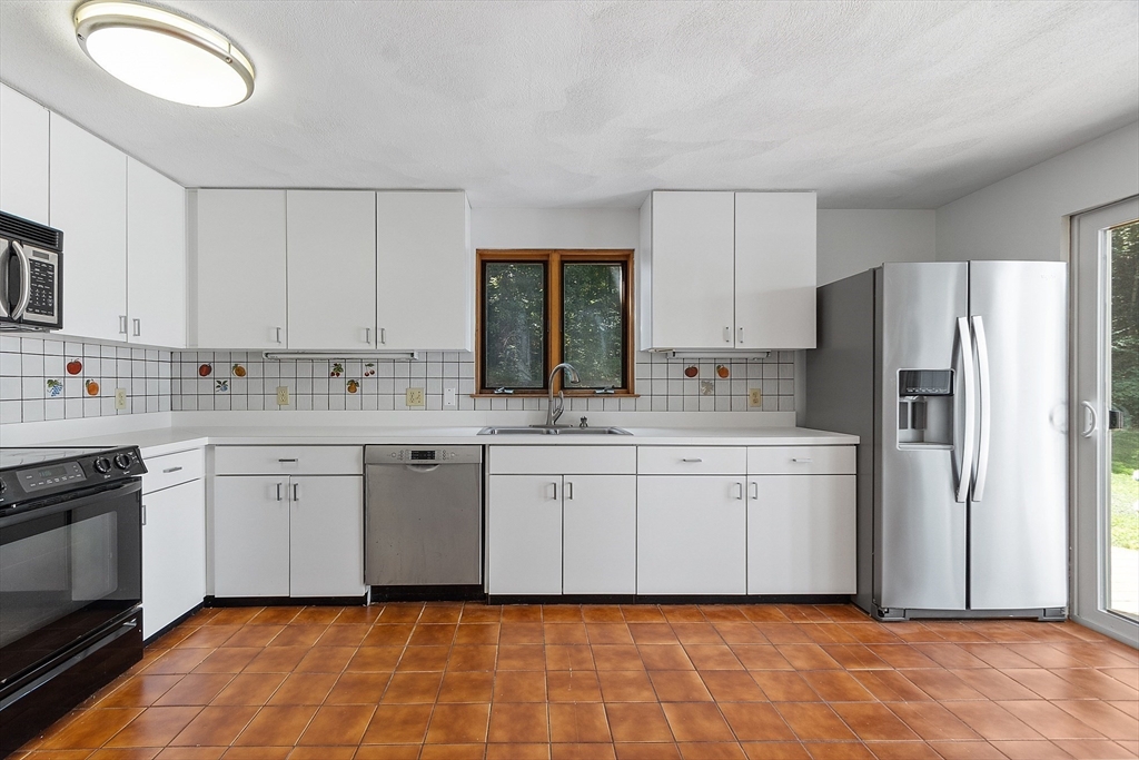 56 Old Littleton Road Harvard, MA 01451 - Photo 13 of 26 a kitchen with white cabinets a sink and white stainless steel appliances