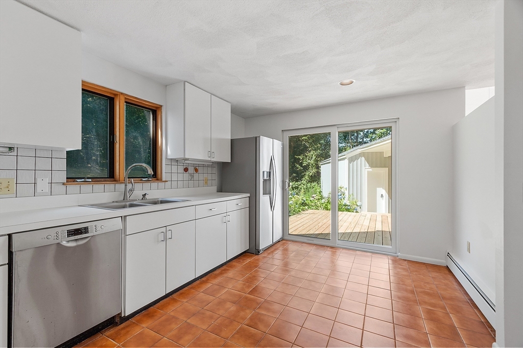 56 Old Littleton Road Harvard, MA 01451 - Photo 14 of 26 a large white kitchen with a sink and a large window