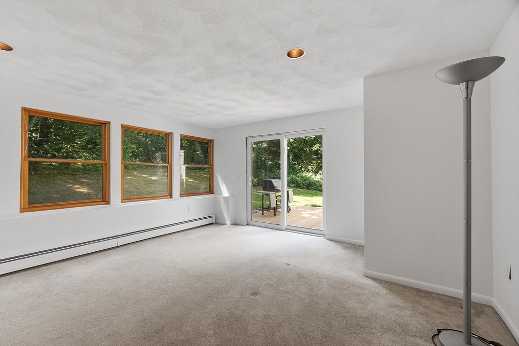 56 Old Littleton Road Harvard, MA 01451 - Photo 16 of 26 a view of an empty room with a window and brick walls