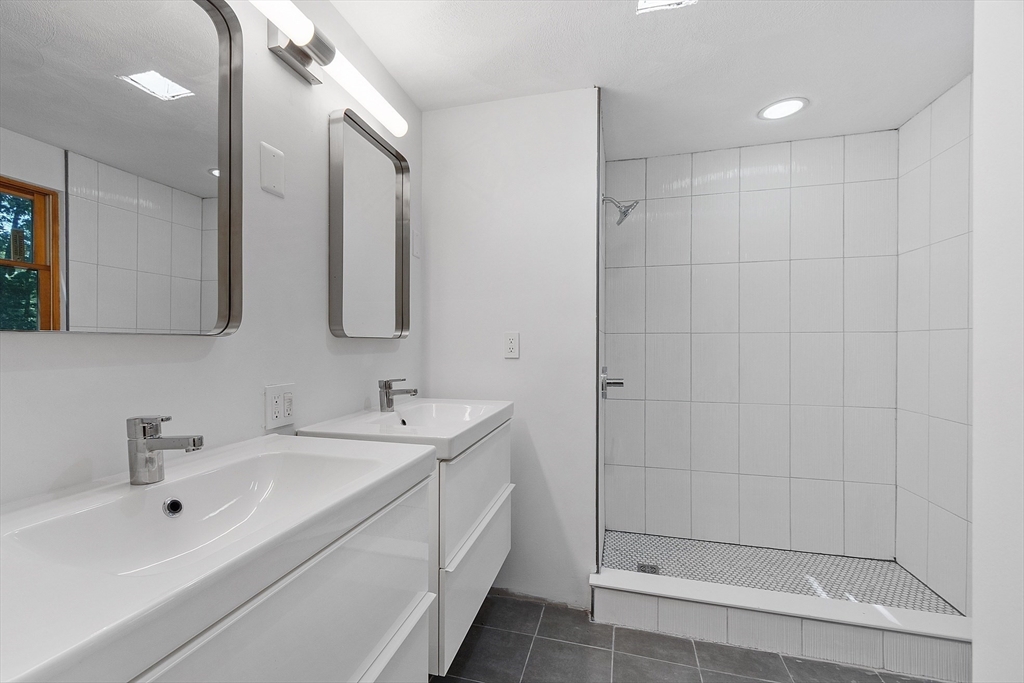 56 Old Littleton Road Harvard, MA 01451 - Photo 17 of 26 a bathroom with a double vanity sink mirror and shower