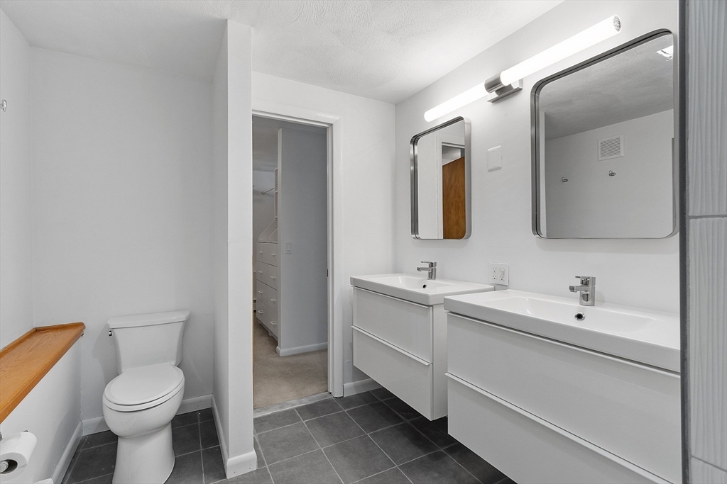 56 Old Littleton Road Harvard, MA 01451 - Photo 19 of 26 a bathroom with a toilet sink double vanity and mirror