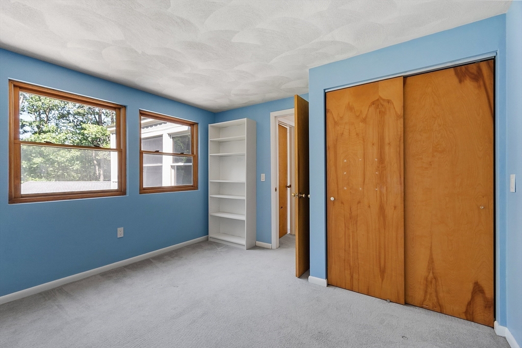 56 Old Littleton Road Harvard, MA 01451 - Photo 24 of 26 an empty room with windows lake and mountain view