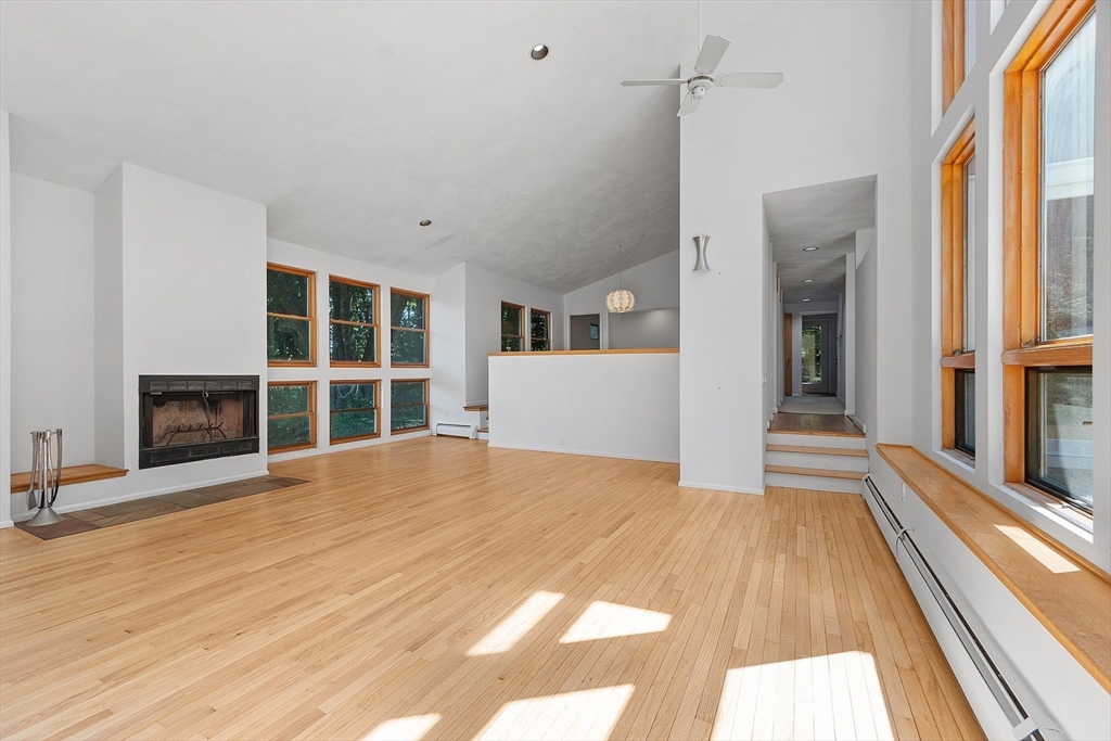56 Old Littleton Road Harvard, MA 01451 - Photo 7 of 26 a view of an empty room with wooden floor and a window