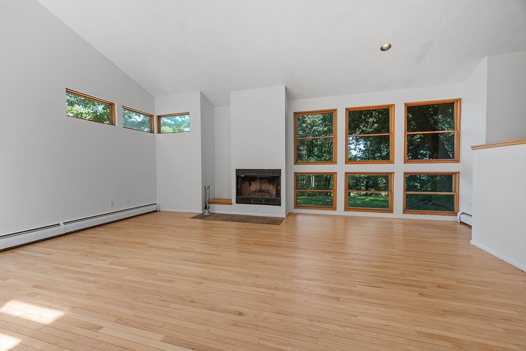56 Old Littleton Road Harvard, MA 01451 - Photo 8 of 26 a view of an empty room with wooden floor and a window