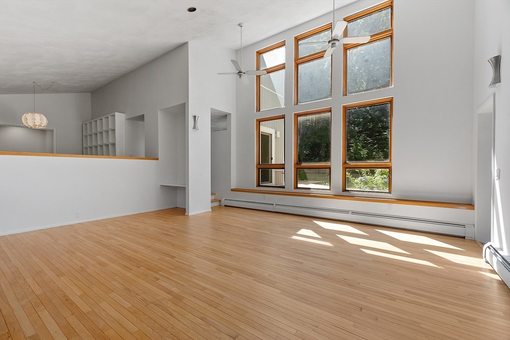 56 Old Littleton Road Harvard, MA 01451 - Photo 9 of 26 a view of an empty room with wooden floor and a window