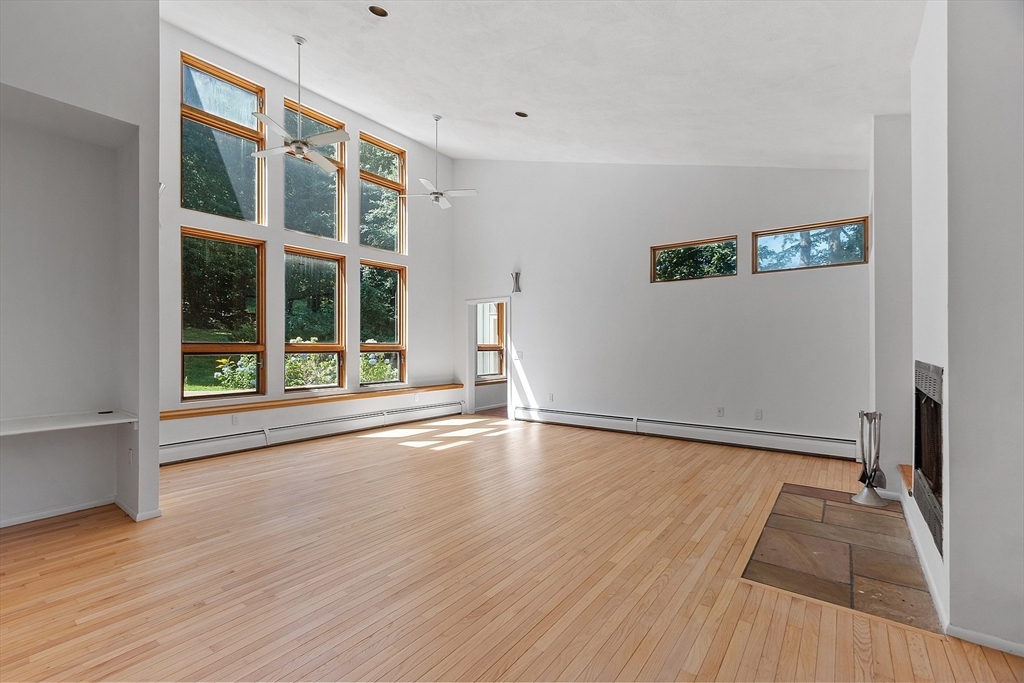 56 Old Littleton Road Harvard, MA 01451 - Photo 10 of 26 wooden floor in an empty room with a window