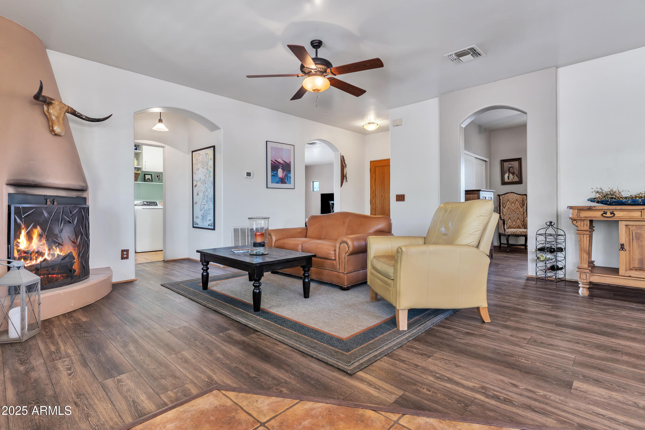 613 South Val Vista Road Apache Junction, AZ 85119 - Photo 7 of 31 a living room with furniture a fireplace and wooden floor