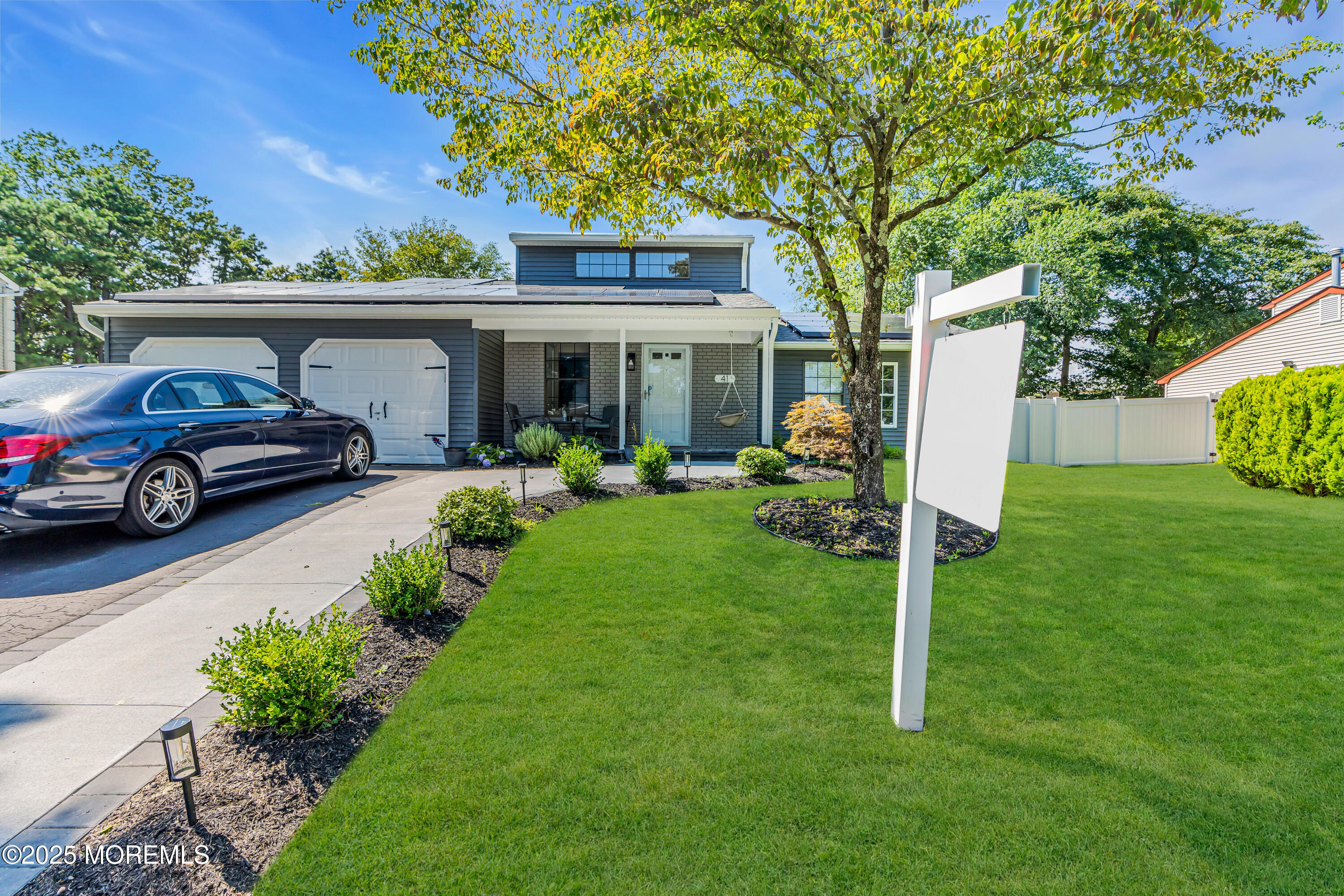 41 Sweetbriar Trail Howell, NJ 07731 - Photo 1 of 11 a front view of a house with garden