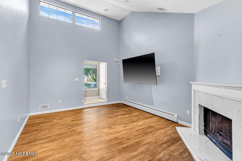41 Sweetbriar Trail Howell, NJ 07731 - Photo 2 of 11 a view of empty room with wooden floor and fireplace