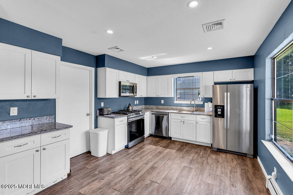 41 Sweetbriar Trail Howell, NJ 07731 - Photo 5 of 11 a kitchen with white cabinets and stainless steel appliances