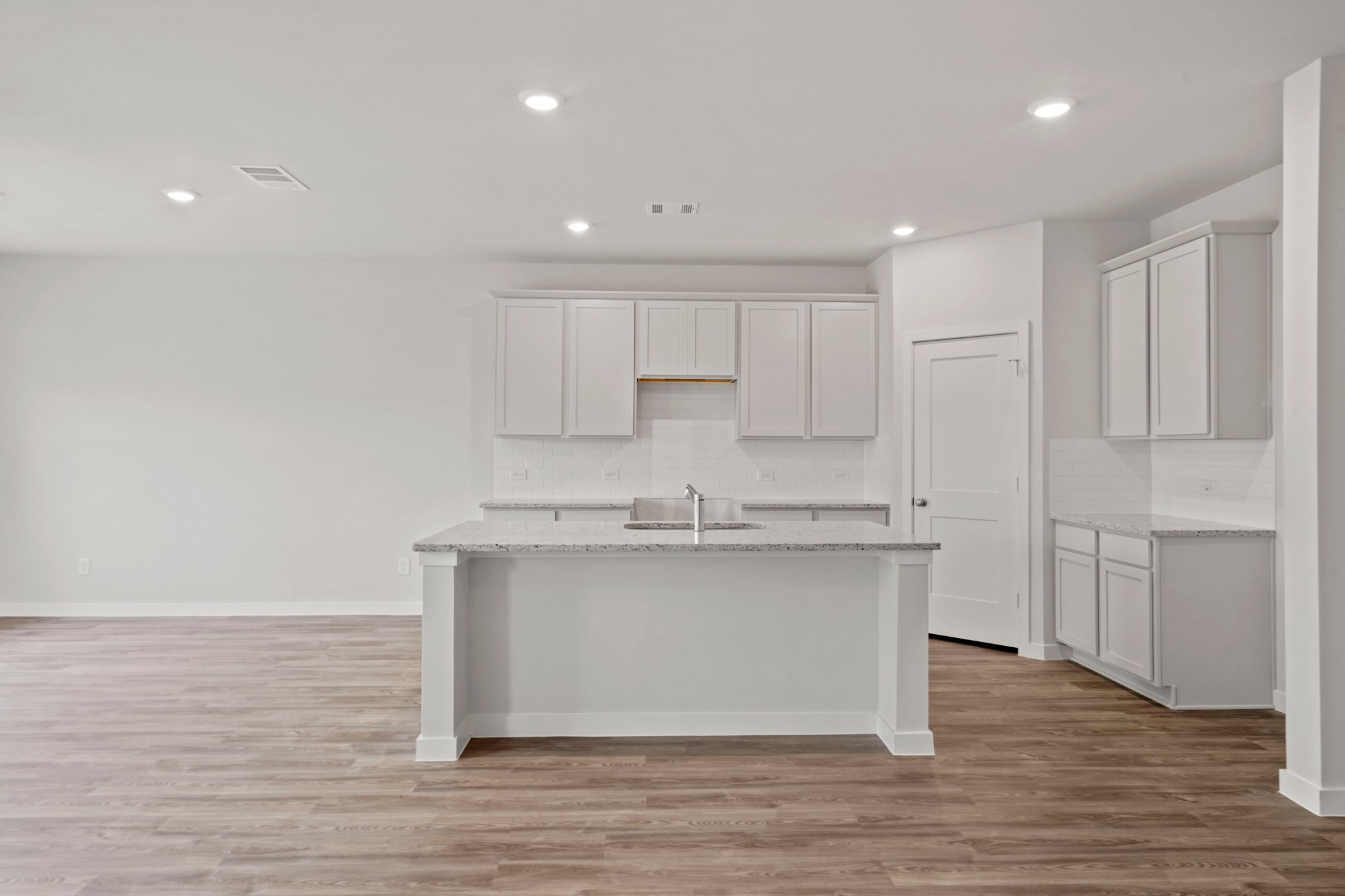 536 Shoreview Drive Conroe, TX 77303 - Photo 3 of 27 a kitchen with stainless steel appliances granite countertop a sink a stove a refrigerator and white cabinets