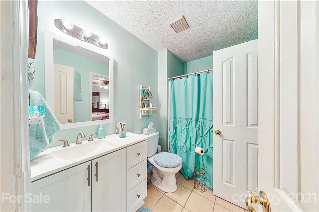 27036 Fahleh Cove Tega Cay, SC 29708 - Photo 14 of 21 a bathroom with a sink a toilet and mirror
