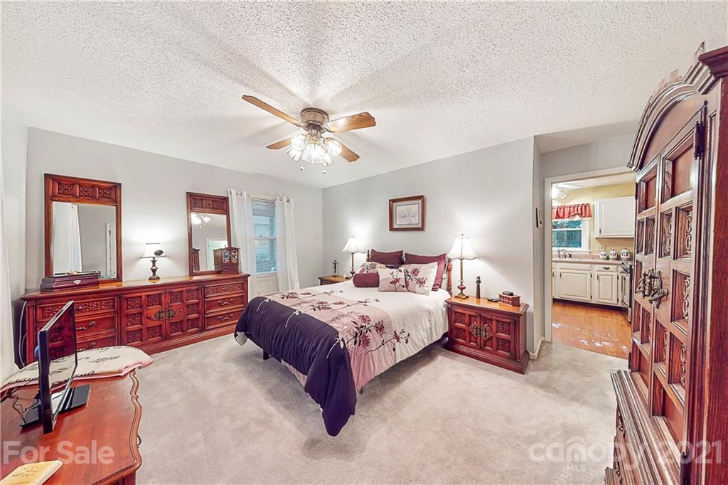 27036 Fahleh Cove Tega Cay, SC 29708 - Photo 15 of 21 a bed room with a bed and a chandelier