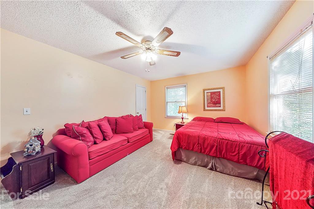 27036 Fahleh Cove Tega Cay, SC 29708 - Photo 17 of 21 a bedroom with bed and a couch
