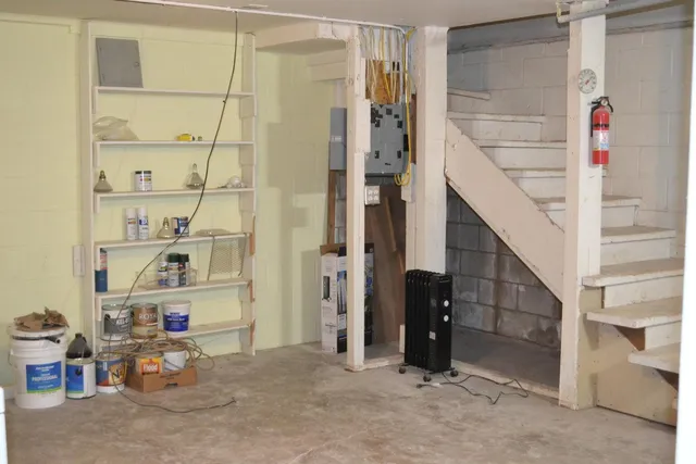 a view of empty room with wooden floor and cabinet