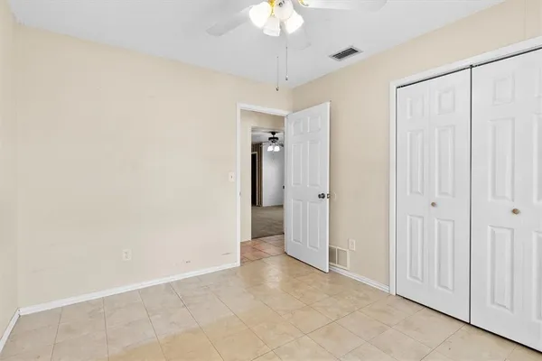 a view of a hallway with a chandelier fan