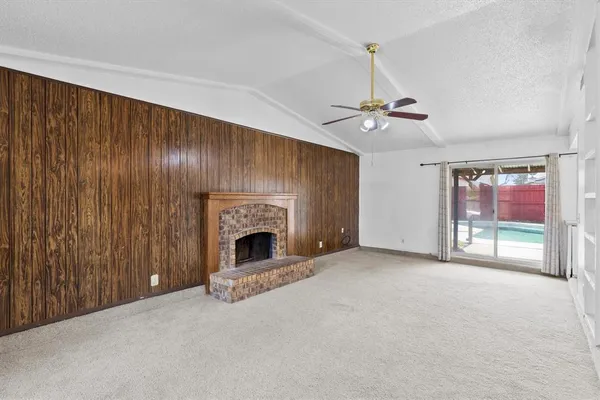 a view of an empty room with a fireplace