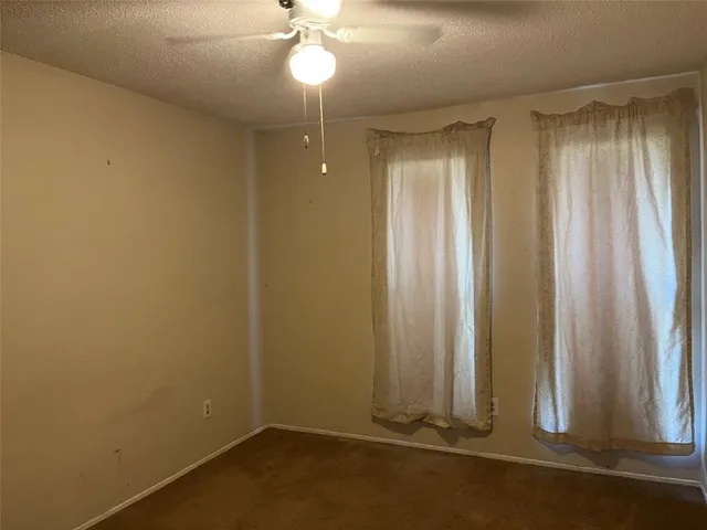a kitchen with granite countertop a sink stove and cabinets