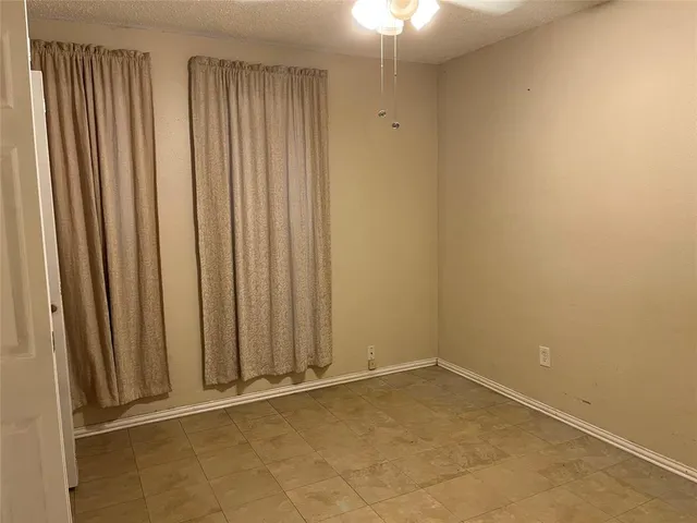 a kitchen with wooden floor and white appliances