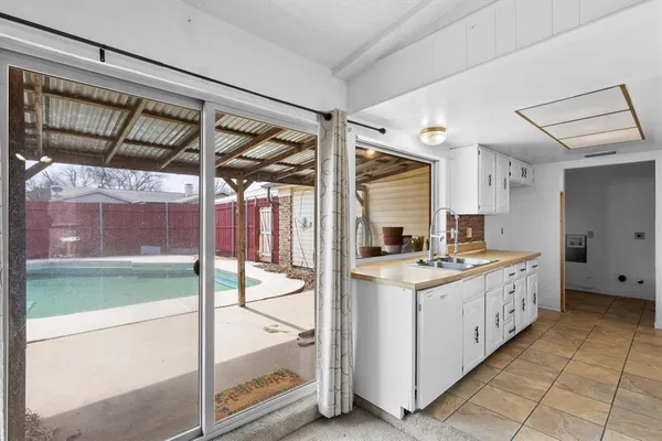 a kitchen with a stove and a view of living room