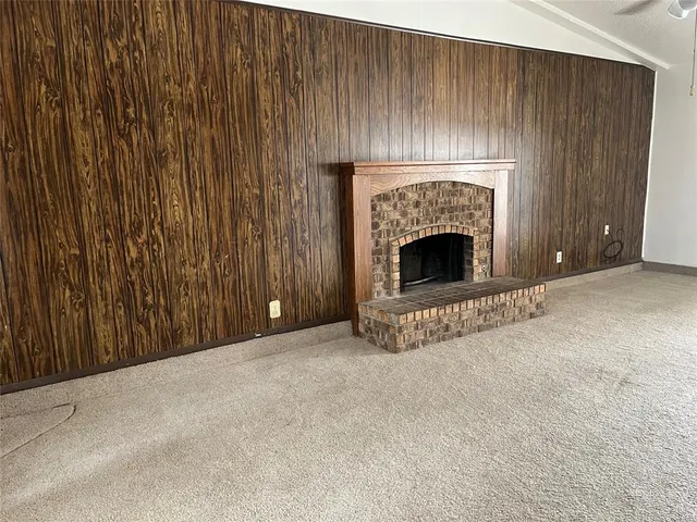 a view of an empty room with a fireplace