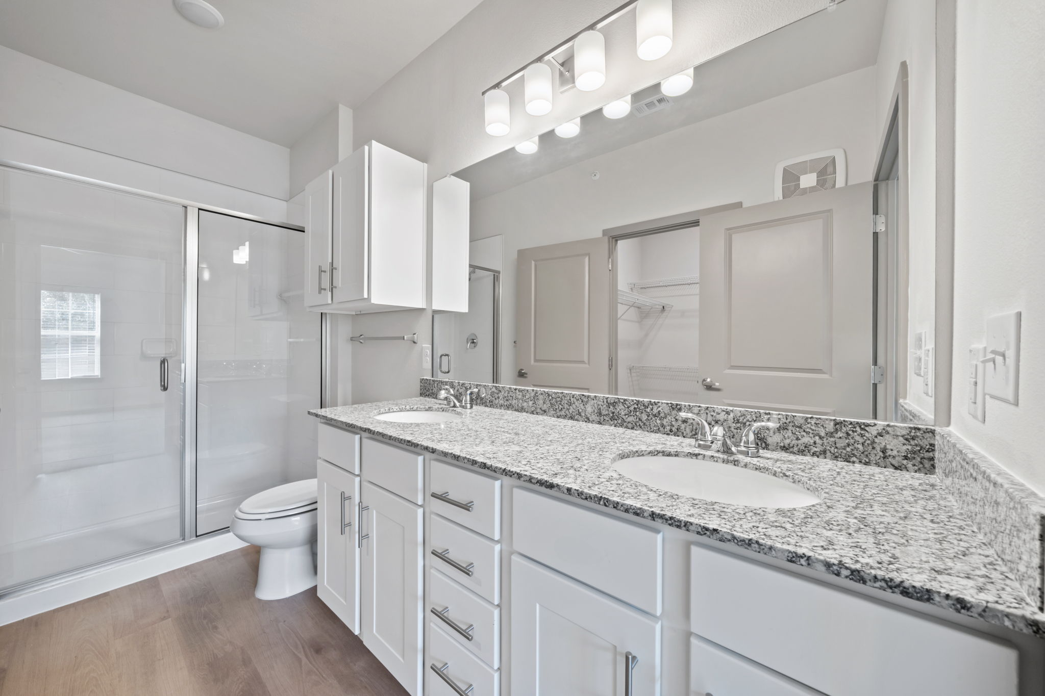 691 Union Chapel Road, Unit S1 Cedar Creek, TX 78612 - Photo 11 of 28 a bathroom with a granite countertop double vanity sink a toilet and a large mirror