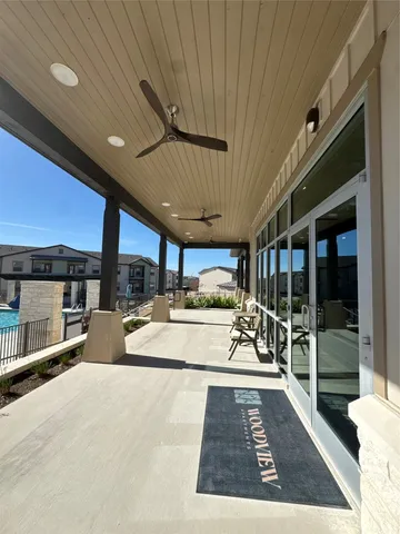 a view of a patio with a table and chairs