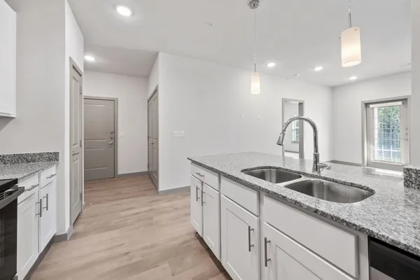 a kitchen with sink and cabinets