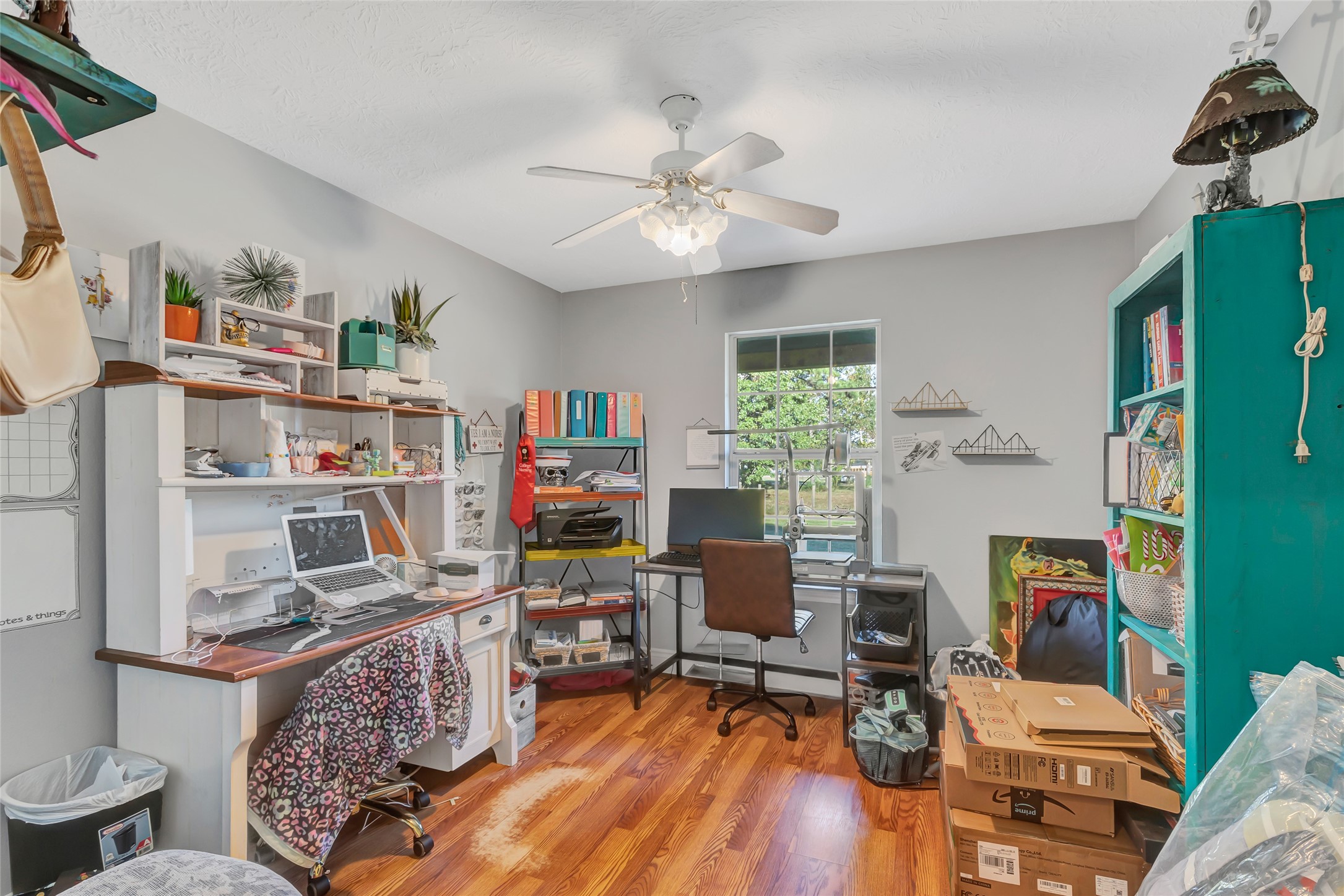 97 County Road 2268 Cleveland, TX 77327 - Photo 15 of 36 a workspace with furniture and a book shelf