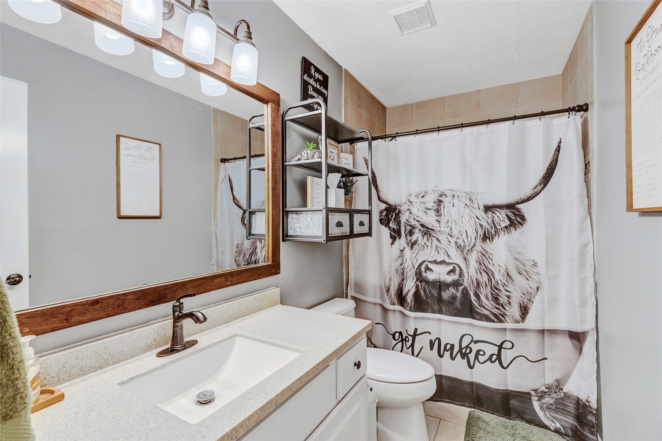 97 County Road 2268 Cleveland, TX 77327 - Photo 22 of 36 a bathroom with a sink toilet and mirror