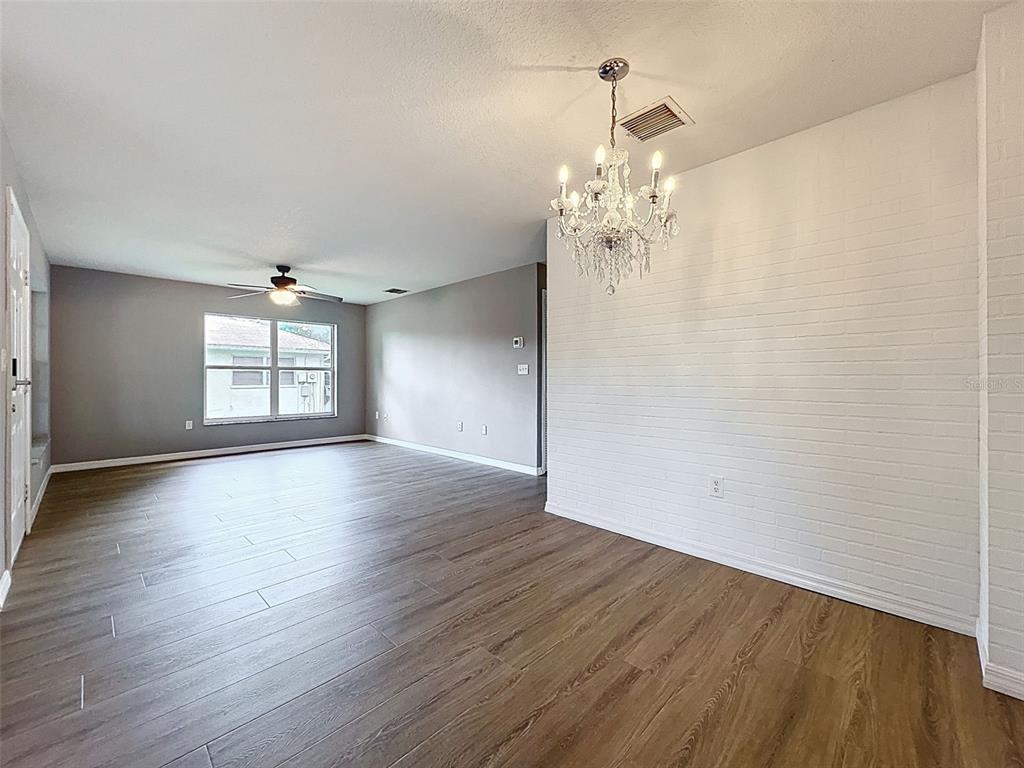 12214 Partridge Hill Row Hudson, FL 34667 - Photo 17 of 80 an empty room with wooden floor and windows