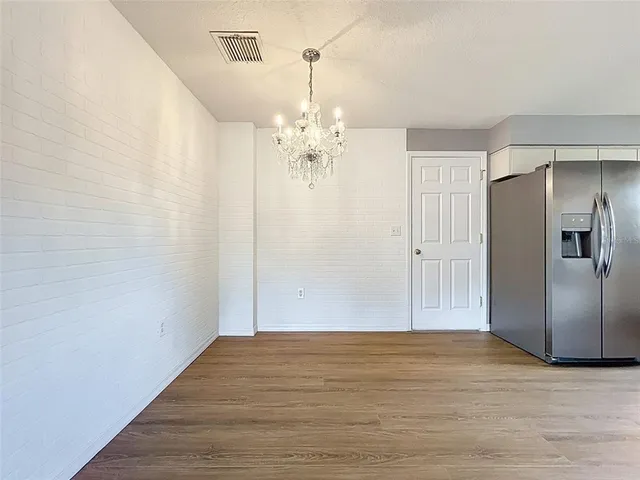 an empty room with wooden floor and a window