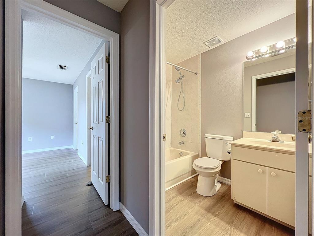 12214 Partridge Hill Row Hudson, FL 34667 - Photo 30 of 80 a view of bathroom with a toilet sink and a mirror