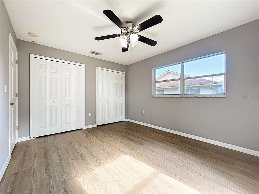 12214 Partridge Hill Row Hudson, FL 34667 - Photo 37 of 80 a view of an empty room with wooden floor and a window