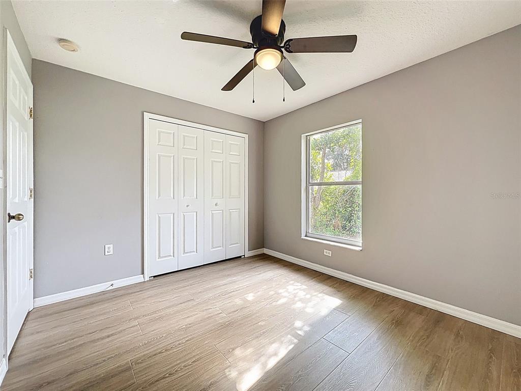 12214 Partridge Hill Row Hudson, FL 34667 - Photo 43 of 80 a view of an empty room with window and wooden floor