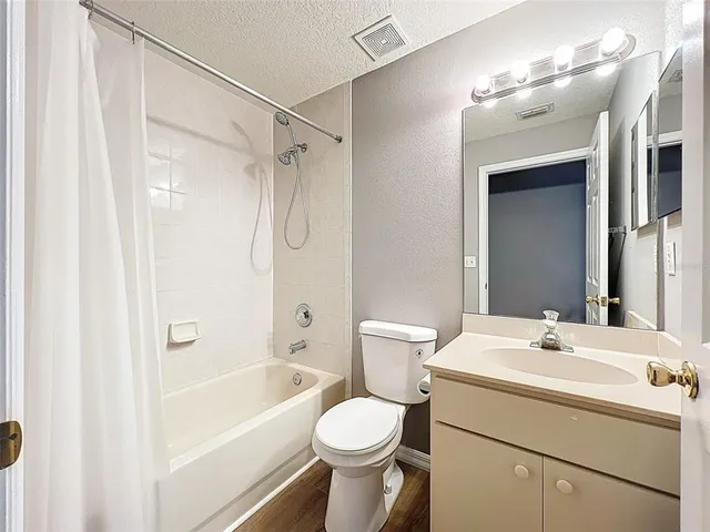 an aerial view of residential houses with outdoor space and street view