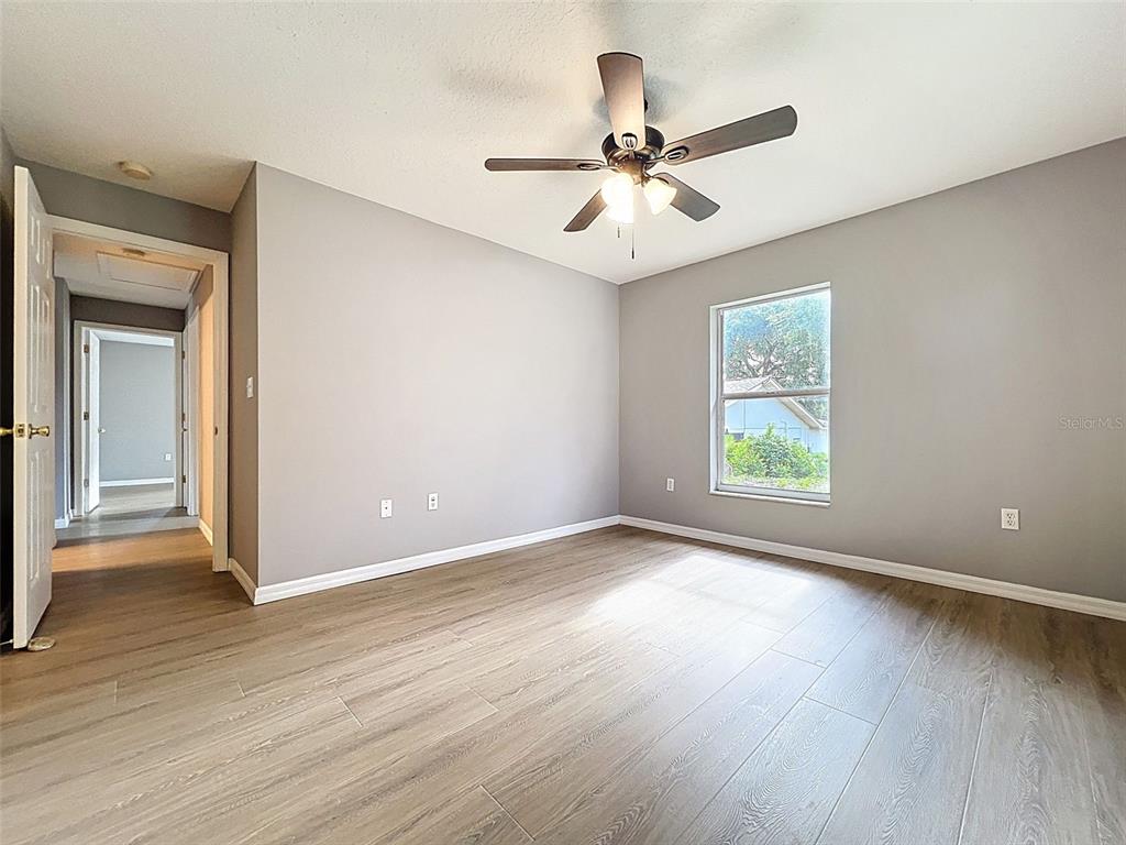12214 Partridge Hill Row Hudson, FL 34667 - Photo 47 of 80 wooden floor in an empty room with a window