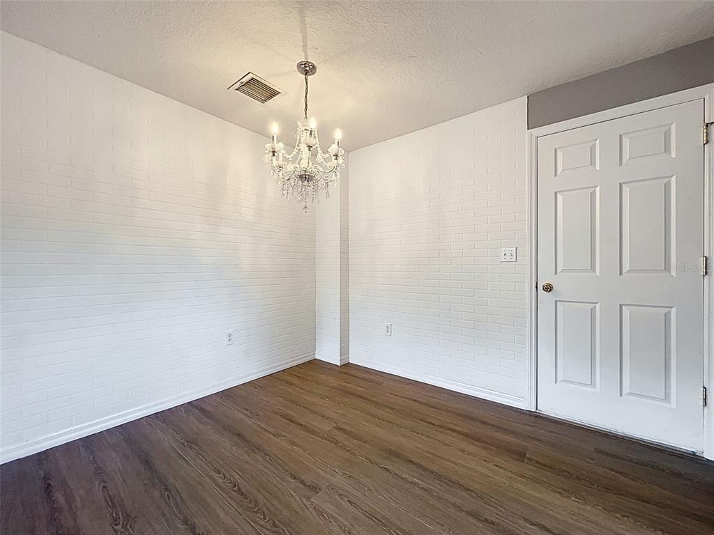 12214 Partridge Hill Row Hudson, FL 34667 - Photo 53 of 80 a view of empty room with wooden floor