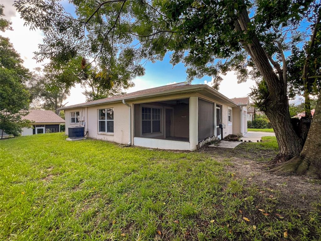 12214 Partridge Hill Row Hudson, FL 34667 - Photo 62 of 80 a view of a house with backyard and garden