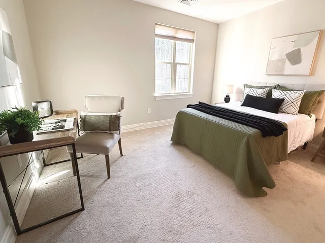 a bedroom with furniture and a window