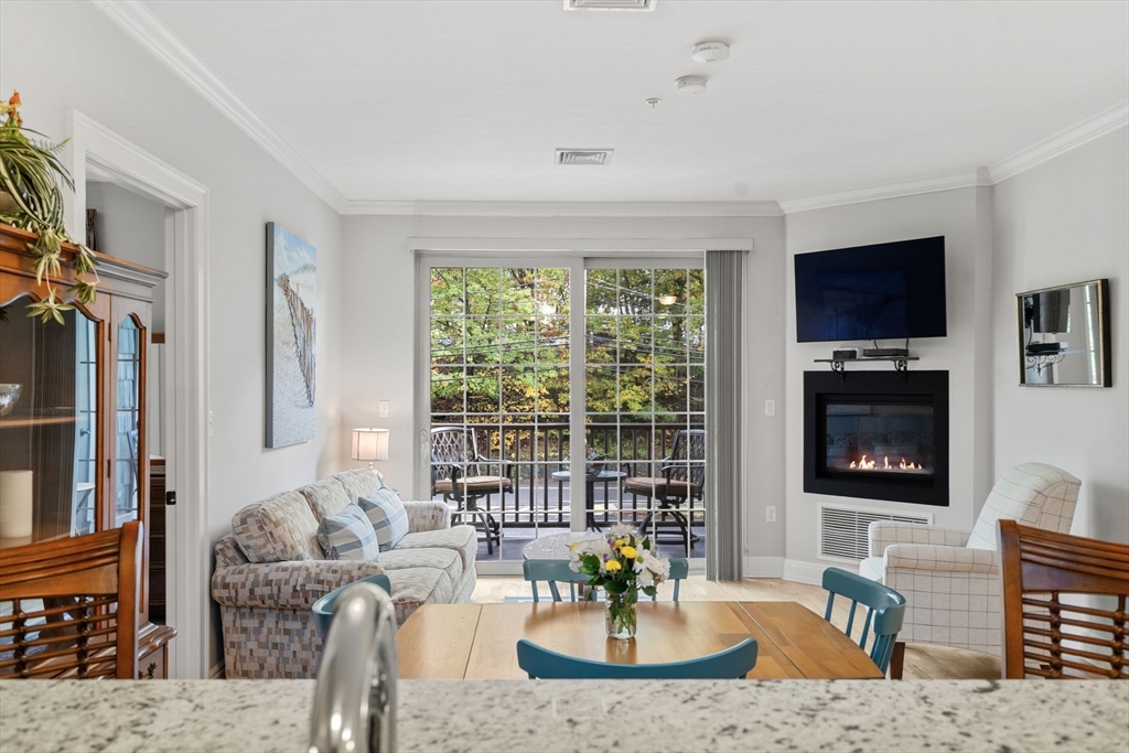 59 Walpole Street, Unit 210 Canton, MA 02021 - Photo 3 of 42 a living room with fireplace furniture and a flat screen tv