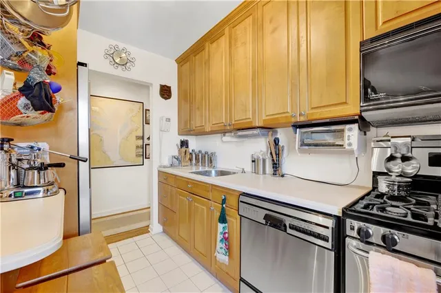 a kitchen with stainless steel appliances a stove a refrigerator and a sink