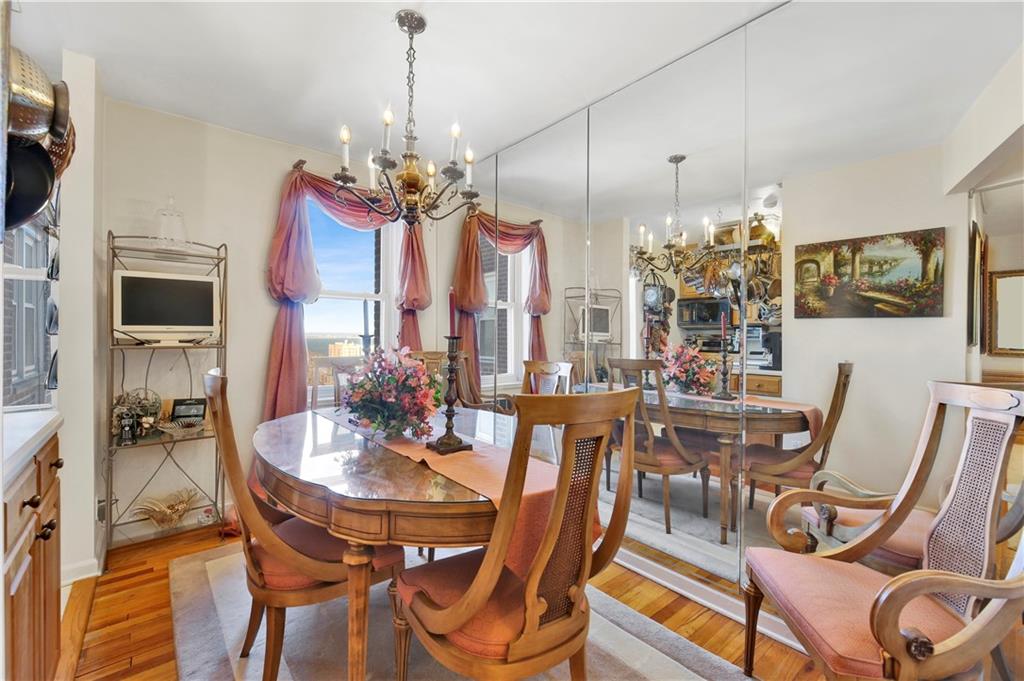 131 74th Street, Unit 6J Brooklyn, NY 11209 - Photo 13 of 21 a view of a dining room with furniture a chandelier and wooden floor