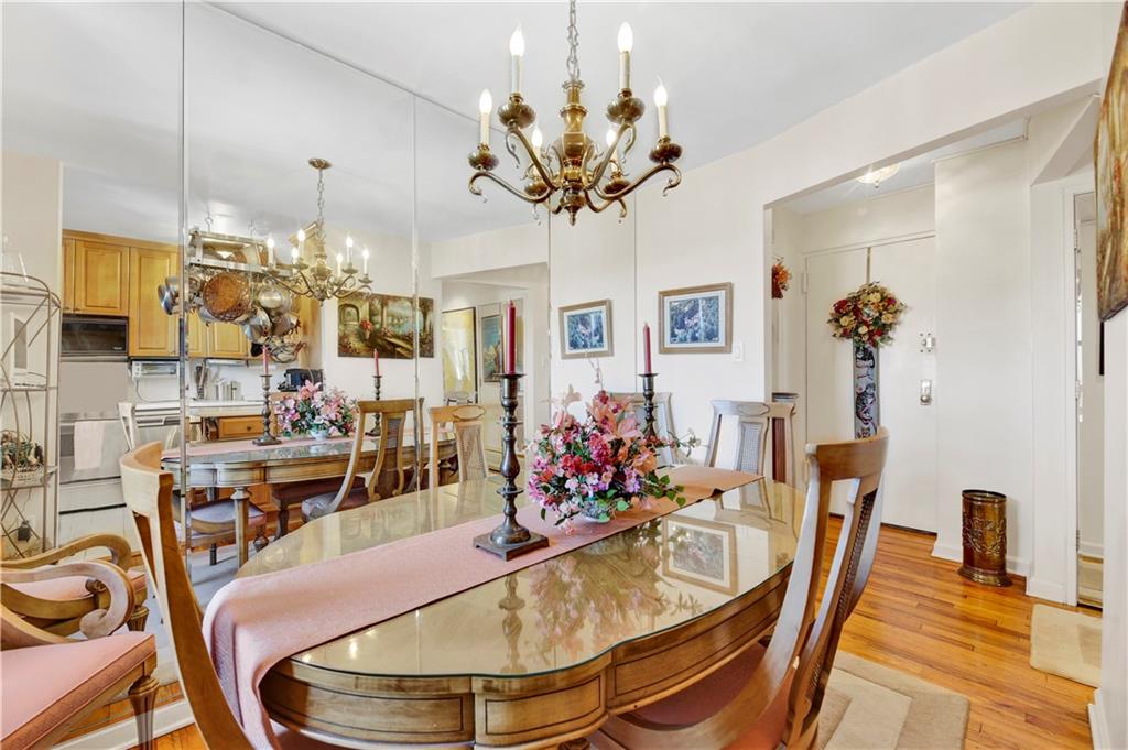 131 74th Street, Unit 6J Brooklyn, NY 11209 - Photo 14 of 21 a view of a dining room with furniture and a chandelier