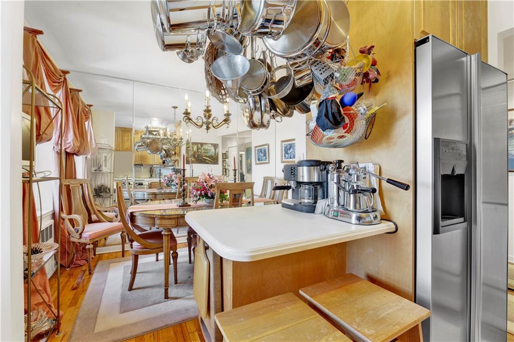 131 74th Street, Unit 6J Brooklyn, NY 11209 - Photo 15 of 21 a view of a dining room with furniture and chandelier