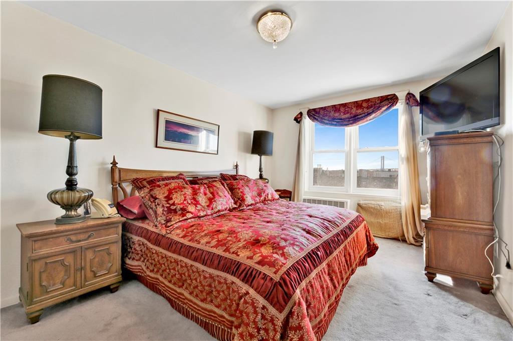 131 74th Street, Unit 6J Brooklyn, NY 11209 - Photo 2 of 21 a bedroom with a bed and a night stand