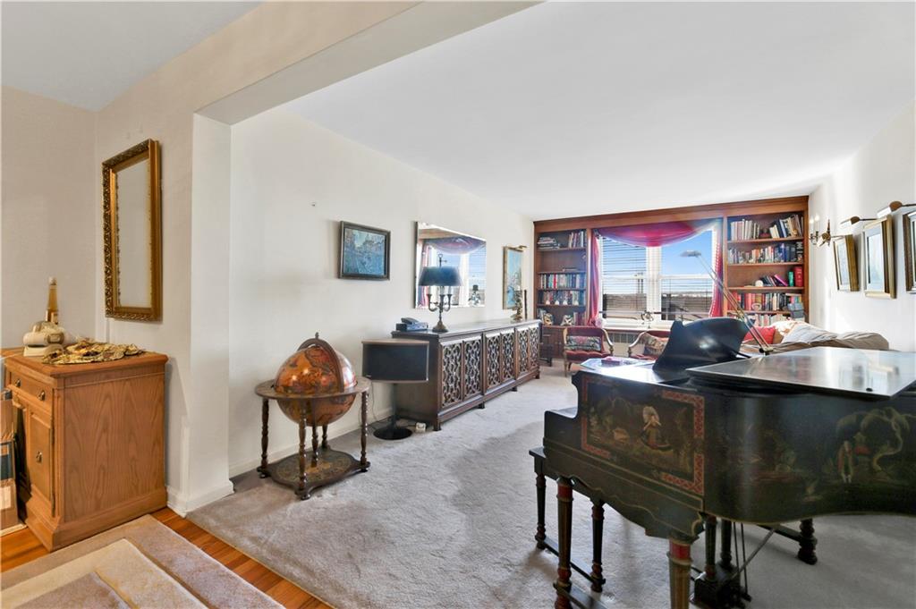 131 74th Street, Unit 6J Brooklyn, NY 11209 - Photo 4 of 21 a living room with furniture a rug and a large window